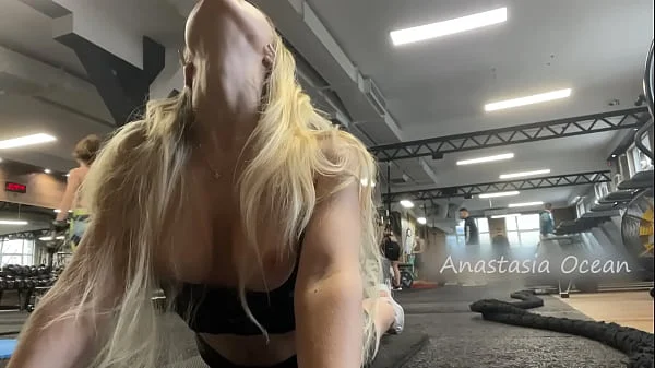 Naughty girl flashing tits in gym right next to the men’s company. Public.