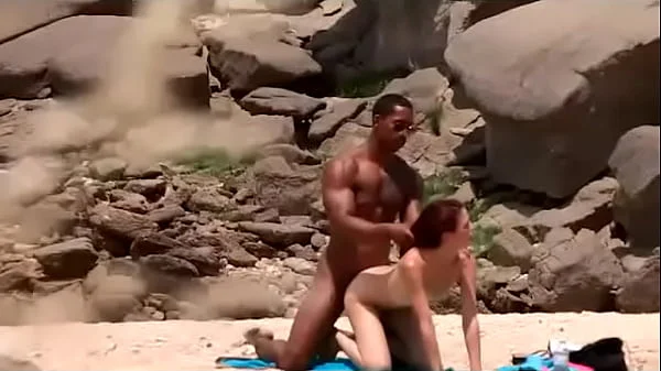 Black dude looks for horny babes at the nude beach and bangs one of 'em