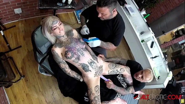 Sascha plays with Amber Luke while she gets tattooed